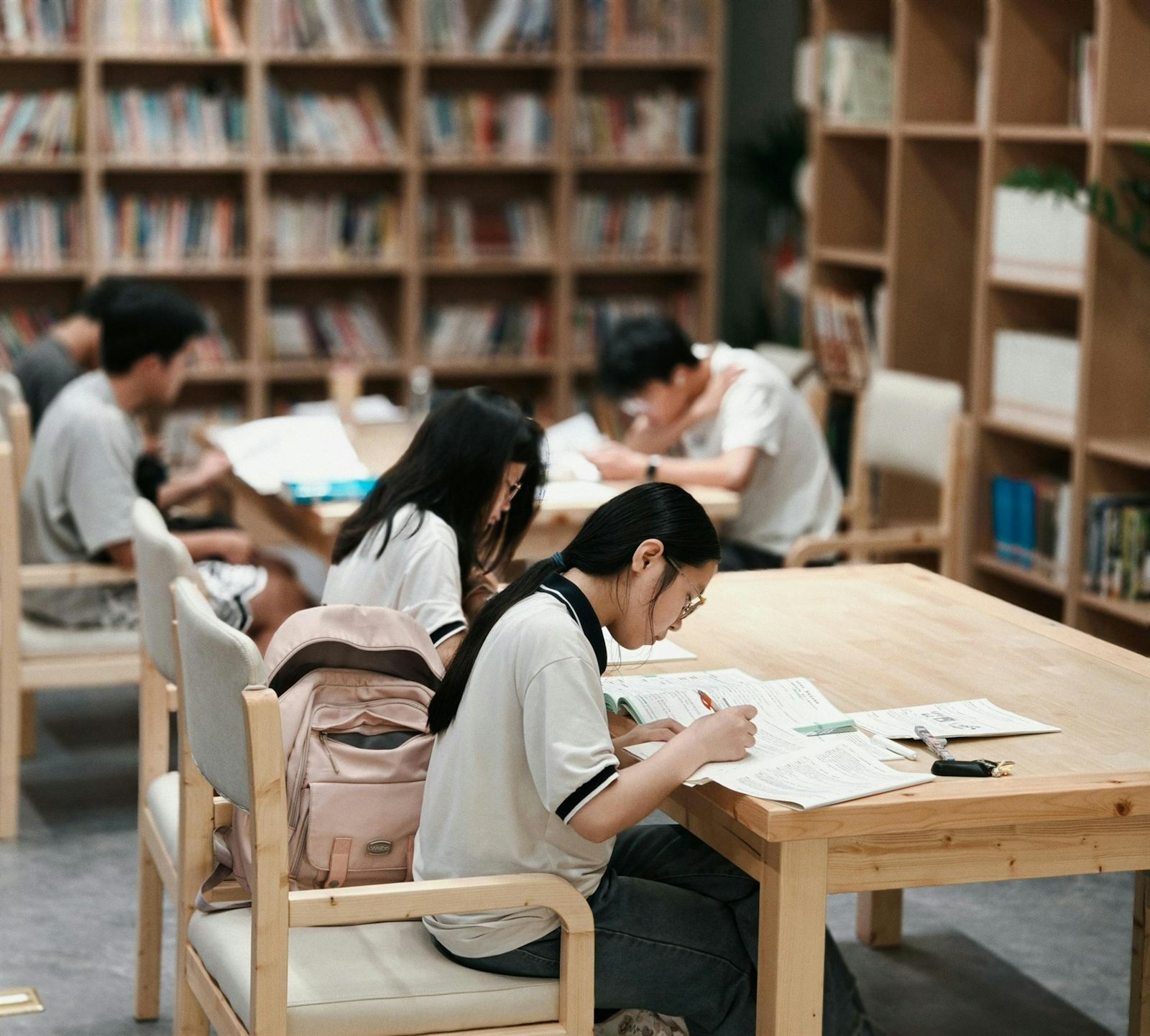 Students studying together at tables in a library